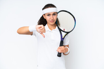 Young tennis player woman isolated on white background showing thumb down with negative expression