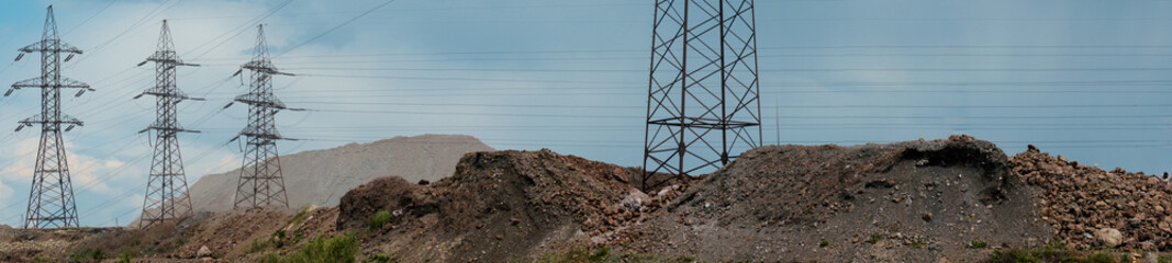 Industrial power Towers and lines releasing - industrial area with slag dumps from the production...