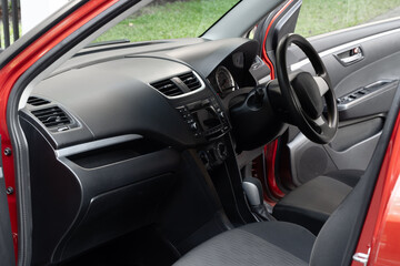 Side view of the open driver's door, glass, dashboard of the car. Front door left, right, new, modern, luxury car, there are a lot inside. modern car interior
