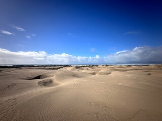 Scenic desert landscape with a stunning sky above sandy terrain near the ocean