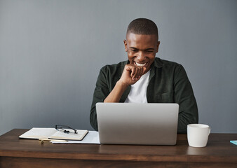 Office, laptop and happy black man reading good news, research and check information in creative...