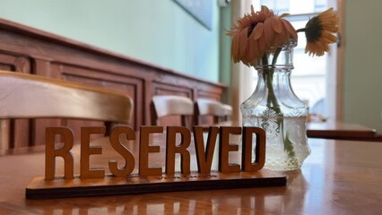 Reserved sign on the table in restaurant. Clouse up. Plate reserved.