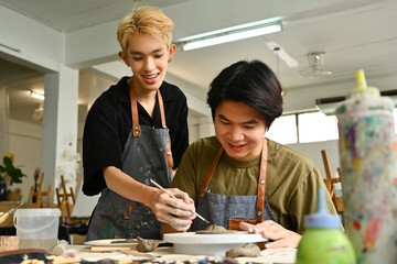 A student joyfully learns pottery with guidance in a creative studio. The image captures the...