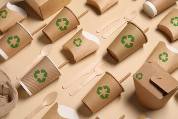 Set of eco friendly food packaging with recycling symbols on beige background