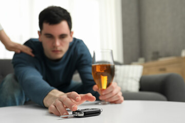Woman stopping man from drunk driving, closeup. Don't drink and drive concept