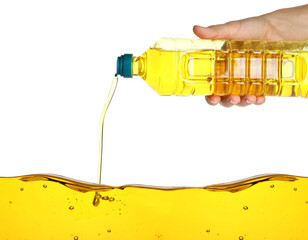 Woman pouring cooking oil from bottle on white background, closeup