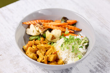 Bowl filled with rice, carrots, and cauliflower