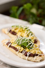 Appetizing sandwiches on a white plate with fresh vegetables