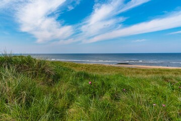 Callantsoog Netherlands Northsea coast with blue sky and little waves