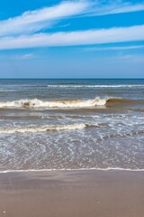 Callantsoog Netherlands Northsea coast with blue sky and little waves