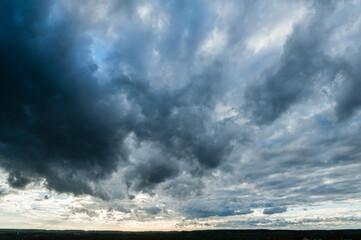 Dramatic dark gray clouds floating in the sky