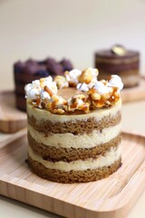 Assorted Seasonal mini cakes. Hazelnut, Opera, Salted Caramel, and Double Chocolate. Endless variety, easy serving, moist layers, rich frosting. A symphony of flavor in every bite. Bakery products. 