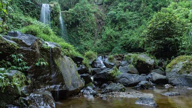 timelapse the beauty of the twin grenjengan waterfalls in the morning. The twin grenjengan waterfalls are located in Pakis District, Magelang, Central Java.