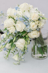 Vase with white and blue flowers on a table