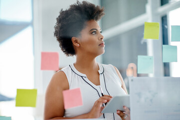Black woman, thinking or brainstorming on glass wall, tablet or sticky note for schedule planning...