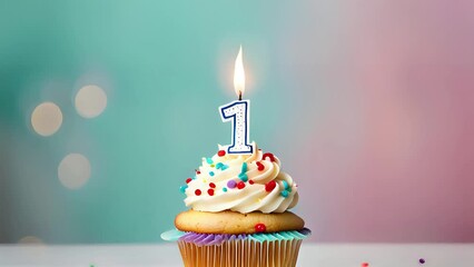 Birthday cupcake with lit birthday candle. Number one for one year or first anniversary.