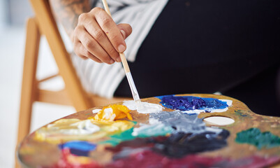 Person, hands and painter with palette in closeup for blending sustainable oil paint and creative expression. Paintbrush, mixing tool and art project with eco friendly materials for inspiration