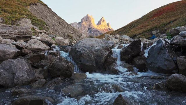 Landscape of Iconic mountain peak of Aiguilles d Arves with waterfall flowing in French Alps at Savoie, France