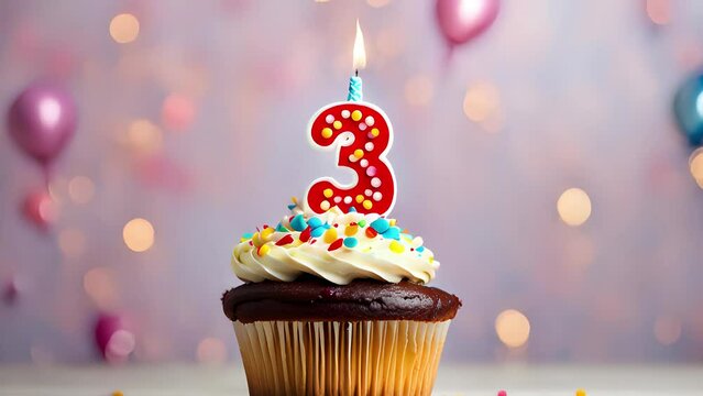 Birthday cupcake with lit birthday candle. Number three for three years or third anniversary.