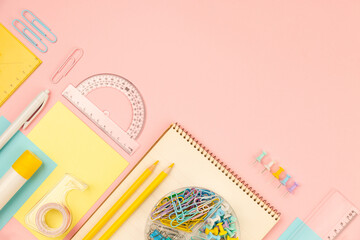 stationery items for girls or women on light pink. Back to school. Female Student's, pupil's or engineer's supplies. Office objects on pastel pink background. Calculator, pen, pencil etc. Copy space