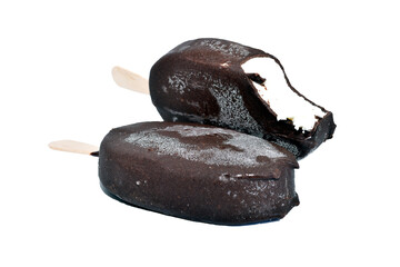 Two ice creams on sticks in chocolate glaze. One is bitten.