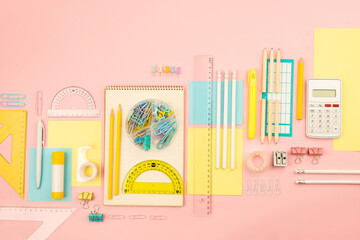 stationery items for girls or women on light pink. Back to school. Female Student's, pupil's or engineer's supplies. Office objects on pastel pink background. Calculator, pen, pencil etc. Copy space