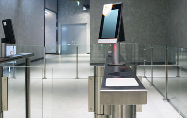 Automatic turnstile speed gate flap barrier with face recognition screen.