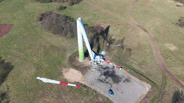 Aerial footage of a broken wind turbine in a wind farm in green field in Taurage, Lithuania