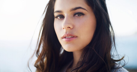 Outdoor, portrait and face of woman, relax and Gen z in nature for break, serious and environment. Calm, person and girl in holiday, weekend and confidence for tourism in vacation and trip in Cancun