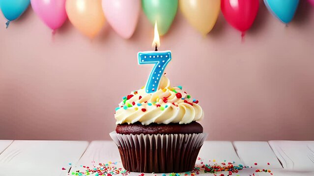 Birthday cupcake with lit birthday candle. Number seven for seven years or seventh anniversary.