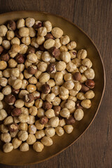 Brown bowl of nuts and a digital timer on a table