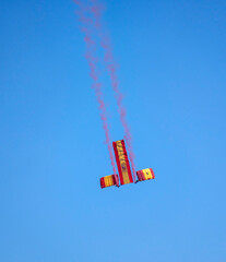 Paratroopers descend with the flag of Spain on Armed Forces Day.
