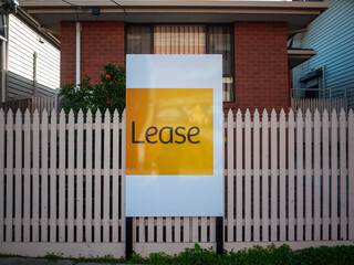 An advertisement sign for a residential property and suburban house listed for lease. Concept of...