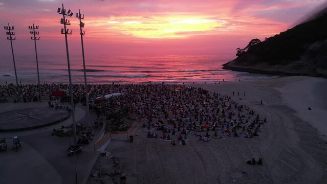 Aerial shot of a group of people Velas Beach meditating at sunrise in Buzios, Rio de Janeiro, Brazil