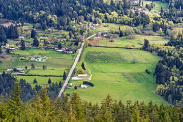small town surrounded by wooded area next to mountains and trees
