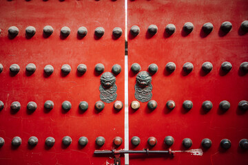 Door adorned with various metal hardware.