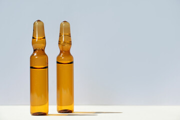 Cosmetic or medical ampoules on a gray background.