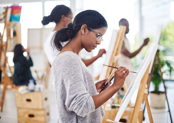 Woman, painting and easel canvas in art class or creativity workshop with learning, watercolor or...