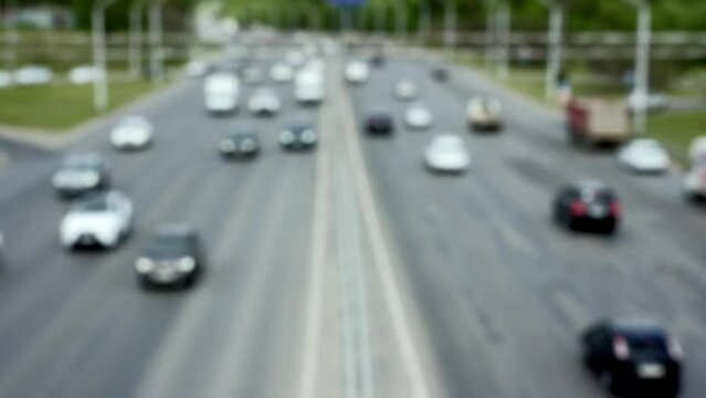 silhouettes of cars moving along the highway, blurred cars, top view of the road