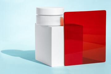 White cosmetic jar with red and blue elements