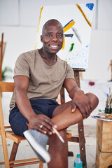 Portrait, happy and African man in art studio for painting, creativity and idea for student...