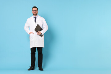 Doctor with clipboard on light blue background, space for text