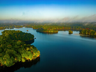 Fototapeta premium Aerial perspective of river and land on a misty day.