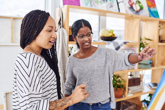 Team, woman and art class with discussion for creative, talking students with idea on painting. Female people, communication or strategy for project with color, collaboration with chat on technique