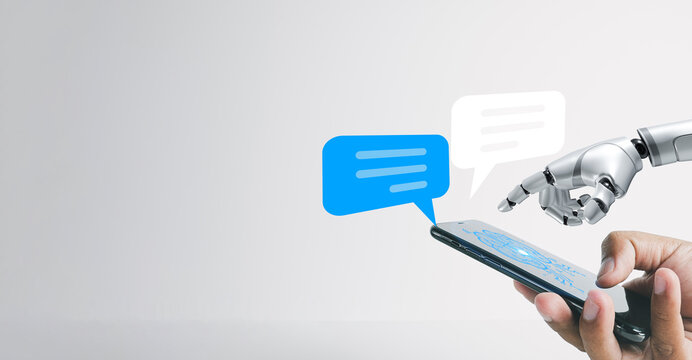 A human hand and a robot hand touching a smartphone screen with a speech bubble icon, idea for  Artificial Intelligence and digital communication,technology, and the future of communication. - Powered by Adobe