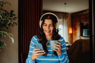 One young girl or woman is listening to music on her wireless headphones in the morning before going to work	