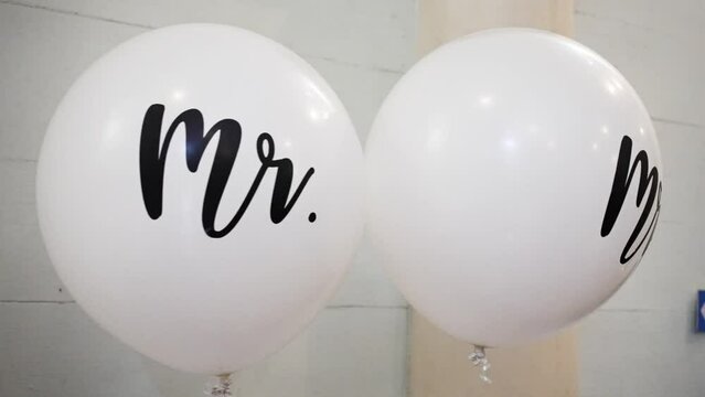White balloons for wedding with Mr. and Mrs. printed on them Slow Motion