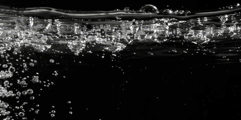 Water Bubbles in a Black Background,Bubbles rising through water with light reflections in a mesmerizing underwater scene
