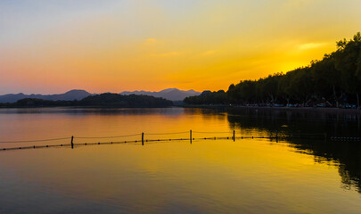 Sunset over the mountains at the West lake in Hangzhou, China