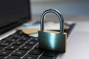 Cyber security. Metal padlock on laptop, closeup